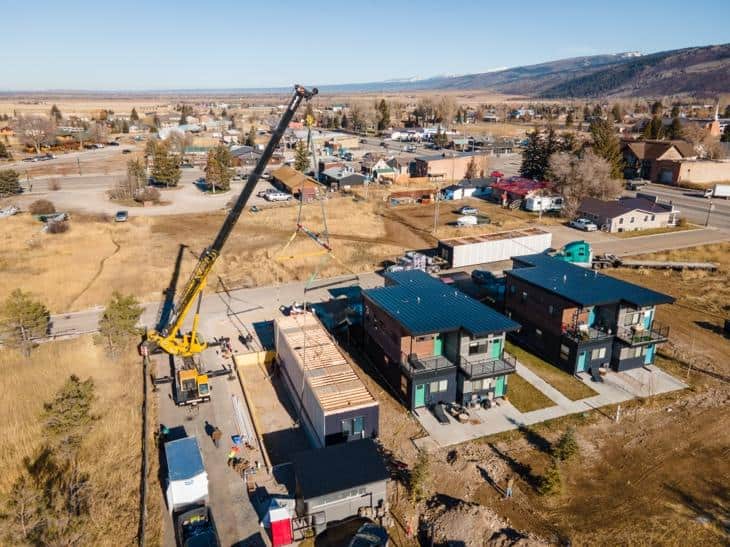 Construction site with Zip Kit Homes being assembled in a rural area.