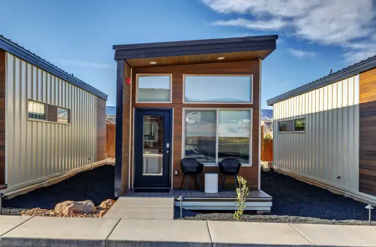 Contemporary Zip Kit modular home with large windows and small porch.