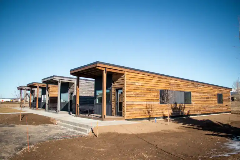 Contemporary Zip Kit Homes with wooden siding and large windows.