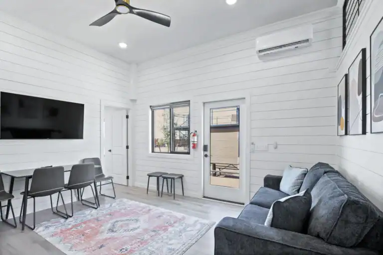 Bright, modern modular living room with white walls and gray furniture.