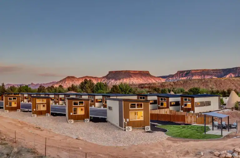 Modern modular homes with desert landscape in the background.