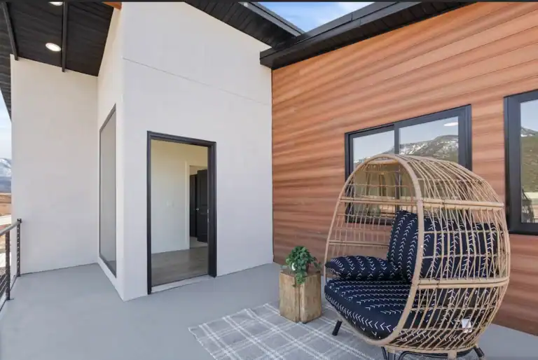 Spacious living room with large windows and modern decor in Zip Kit Homes.
