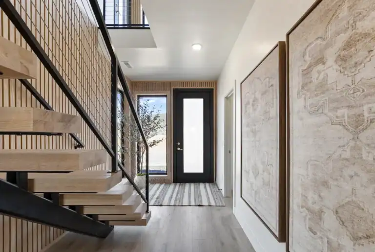 Contemporary entryway with staircase and wall art in Zip Kit Homes.