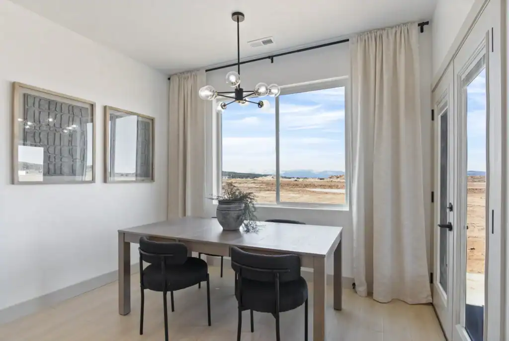 Oakley dining area with large window, modern light fixture, and outdoor views
