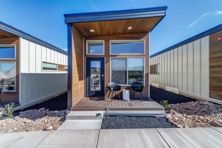 Contemporary Zip Kit modular home with front porch and large windows.