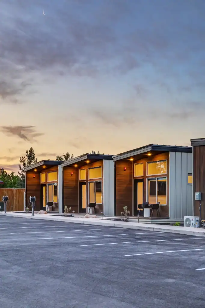 Modern Zip Kit Homes modular units with parking at sunset.