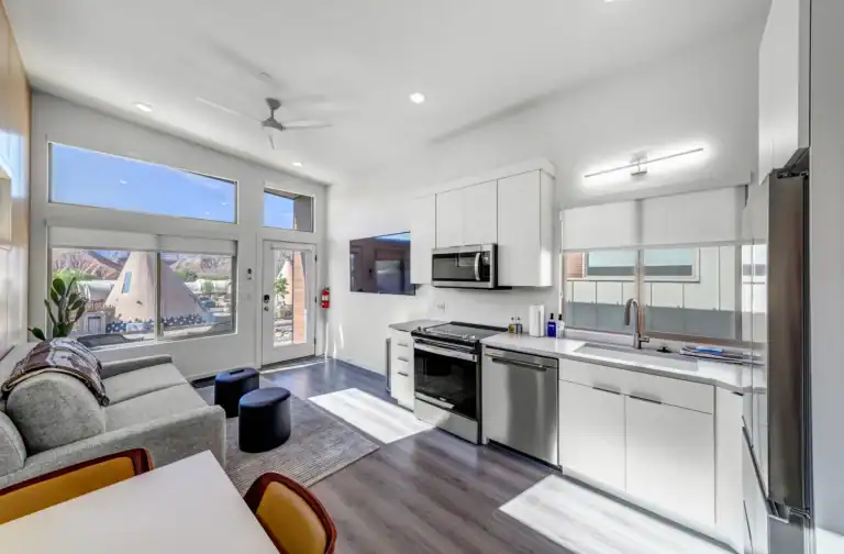 Contemporary modular Zip Kit Homes with illuminated interiors at dusk.