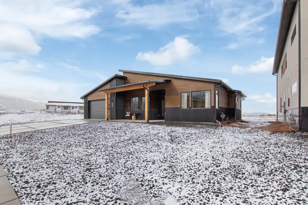 Oakley modern home exterior with clean lines, mixed siding, and landscaped front yard