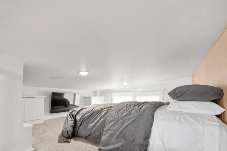 Modern bedroom in a modular home with minimalist design and neutral colors.