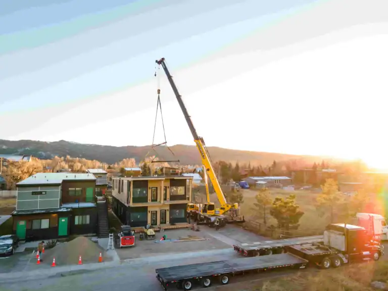 Construction of Zip Kit Homes with crane lifting materials.