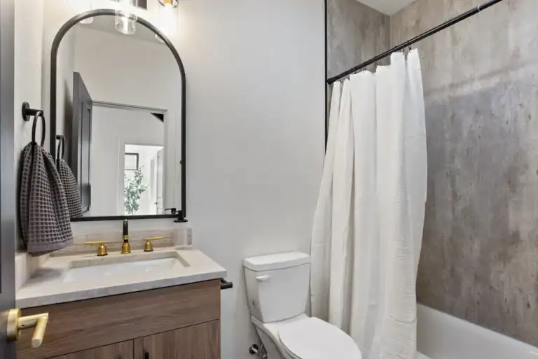 Contemporary bathroom with shower, toilet, and vanity in a minimalist style.