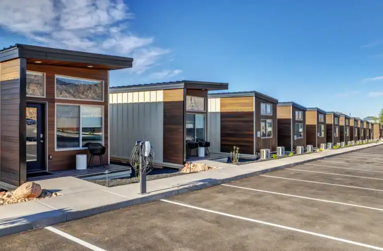 Modern Zip Kit Homes in a row with parking spaces.