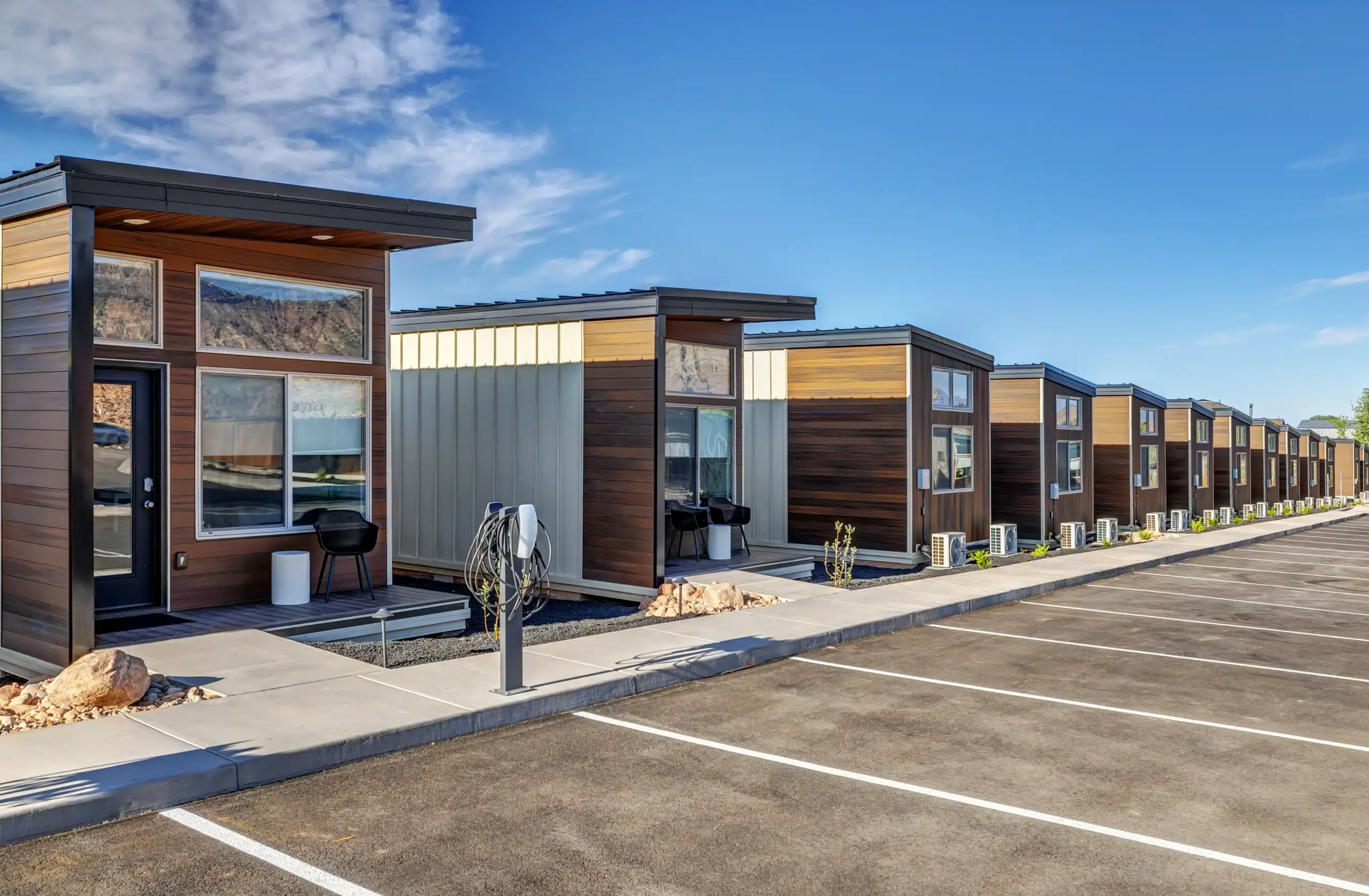 Modern Zip Kit Homes in a row with parking spaces.