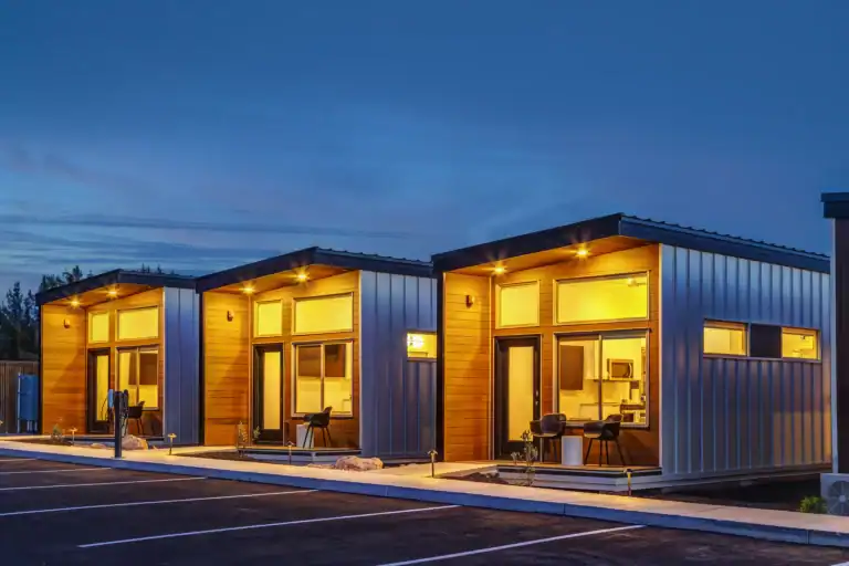 Contemporary Zip Kit Homes with large windows and modern design at dusk.