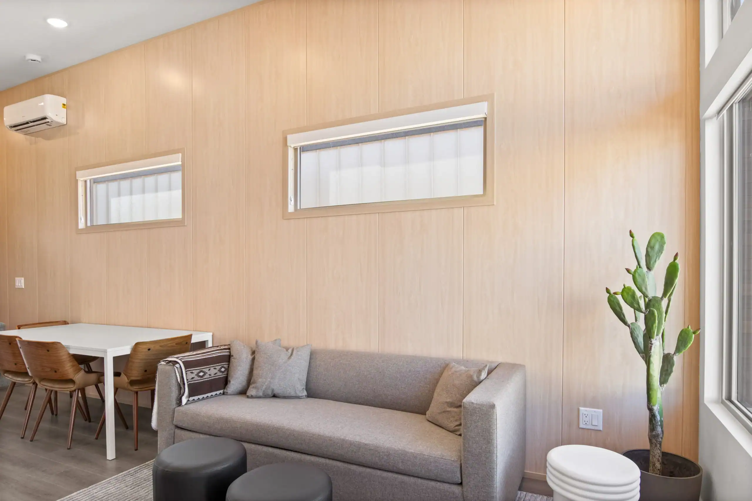 Bright living room with large windows and minimalist decor.