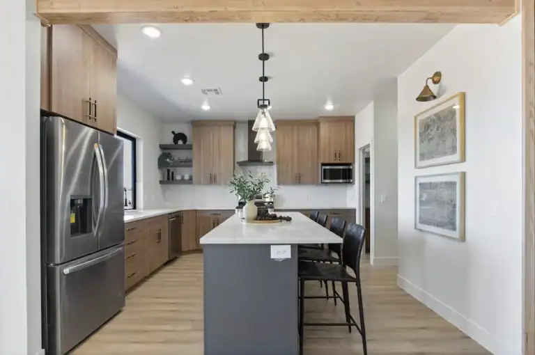 Contemporary kitchen with wooden cabinets and island in Zip Kit Homes.