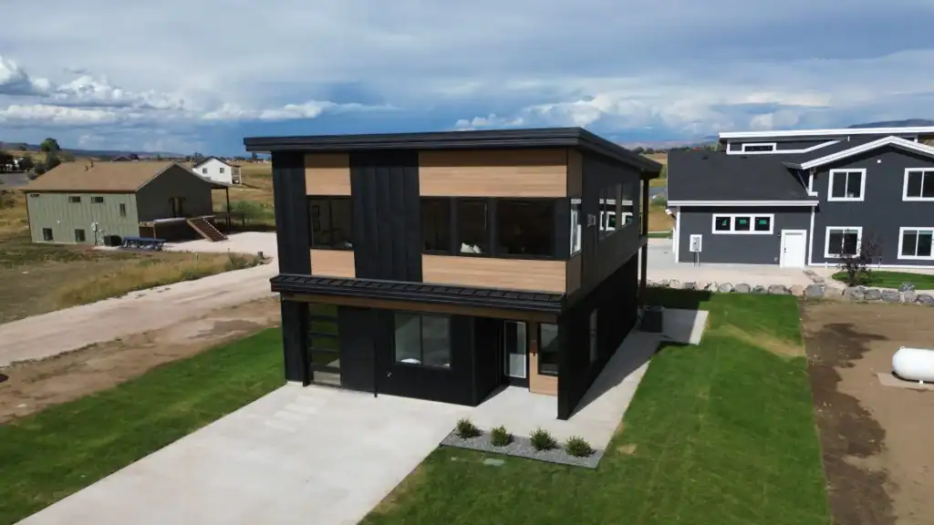 Under construction Zip Kit home with black-framed windows in Bozeman.