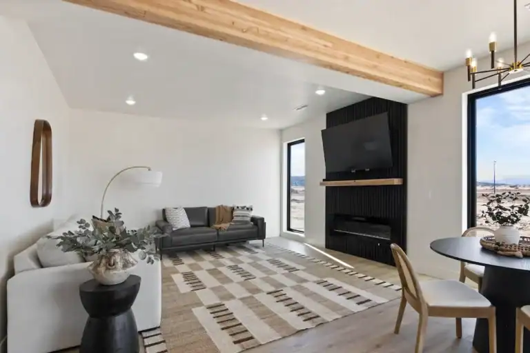 Contemporary living room with minimalist design and large windows.