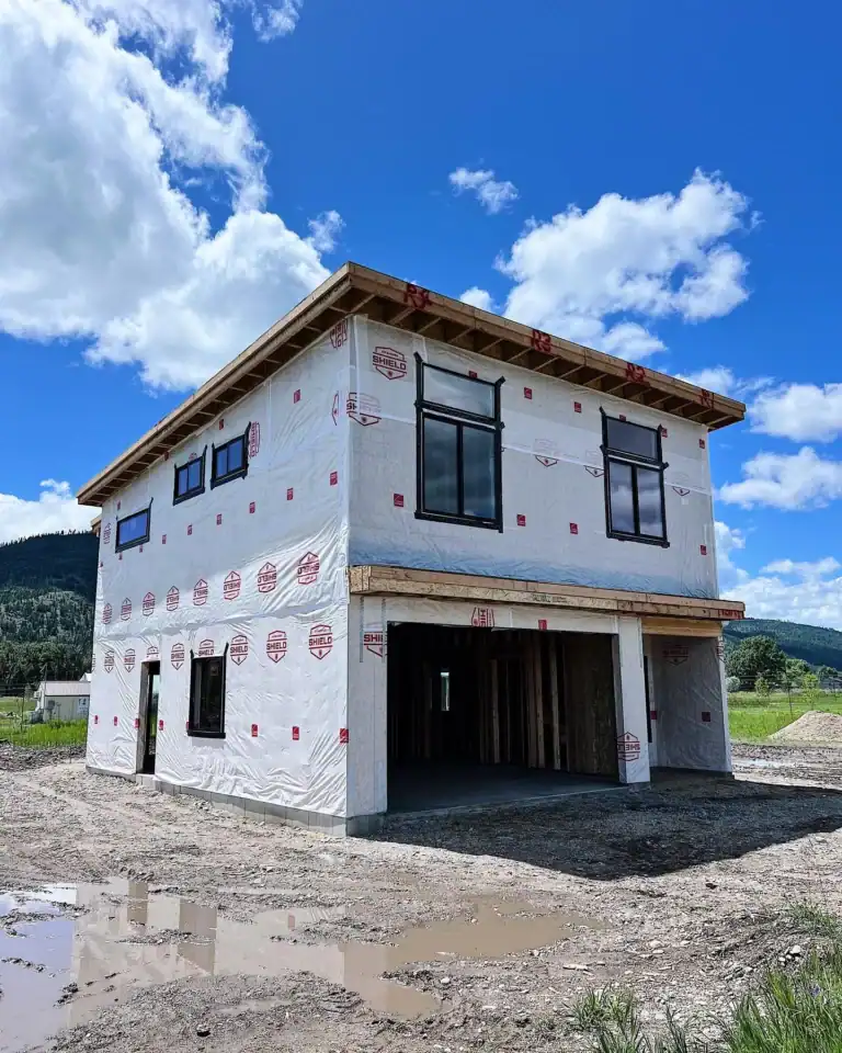 Under construction Zip Kit home with black-framed windows in Bozeman.