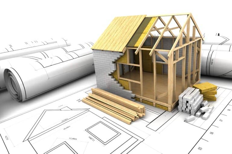 Customizable modular home under construction with framing and blueprints.