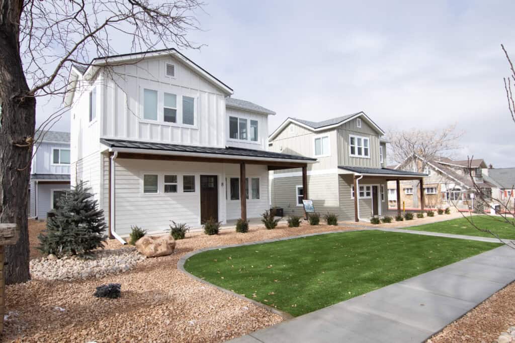 Contemporary Zip Kit Homes with well-maintained lawns and sidewalks.