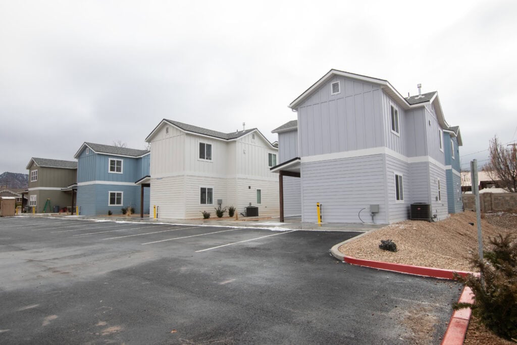 New Clyde tiny homes with colorful exteriors in a residential area.