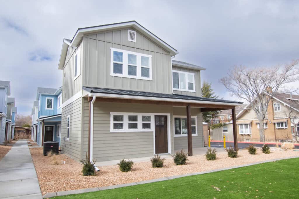 Contemporary Clyde tiny home with a covered porch and large windows, perfect for compact living.