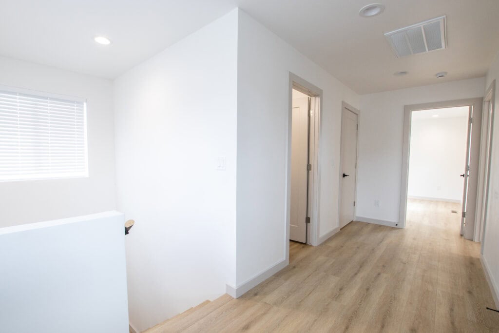 Bright, minimalist interior of the Clyde tiny home by Zip Kit Homes.