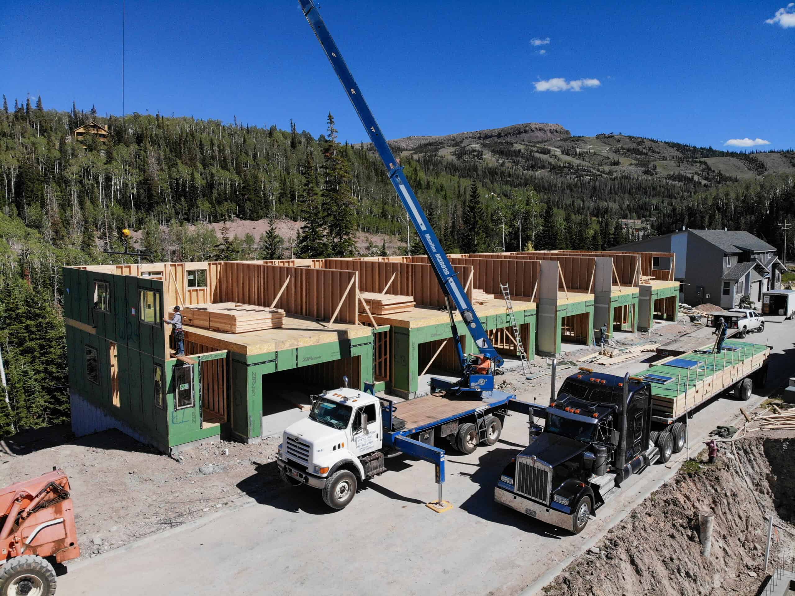 Clayton development homes under construction using panelized home kits with crane.