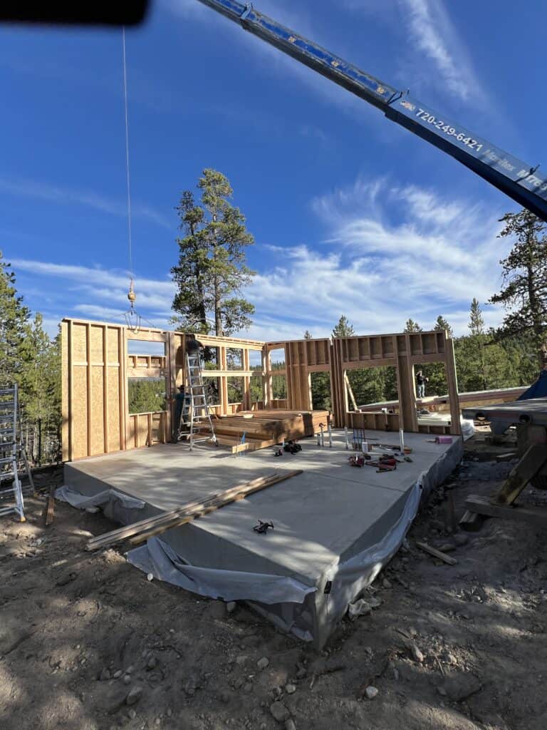 Moab model home framing with exposed structural lumber and partially constructed exterior.