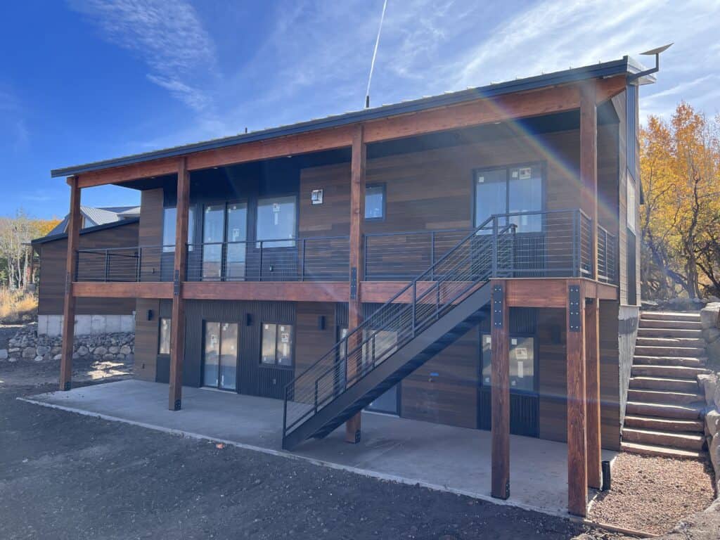 Moab model rear exterior with elevated deck, exterior staircase, and lower-level access.