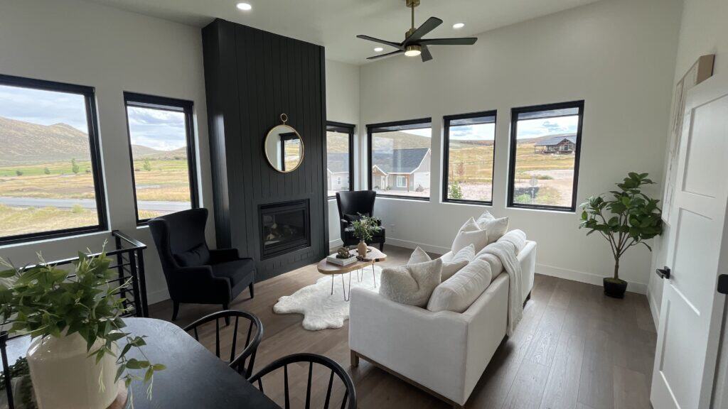 Bozeman living room with modern fireplace, large windows, and open seating area with natural light.