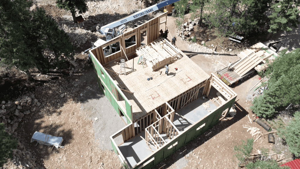 Bozeman model by Zip Kit Homes during build with exposed framing and installed subfloor and wall panels