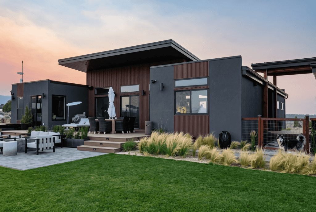 Trent Palmer home rear patio with outdoor seating, main living area, and breezeway connection to garage.