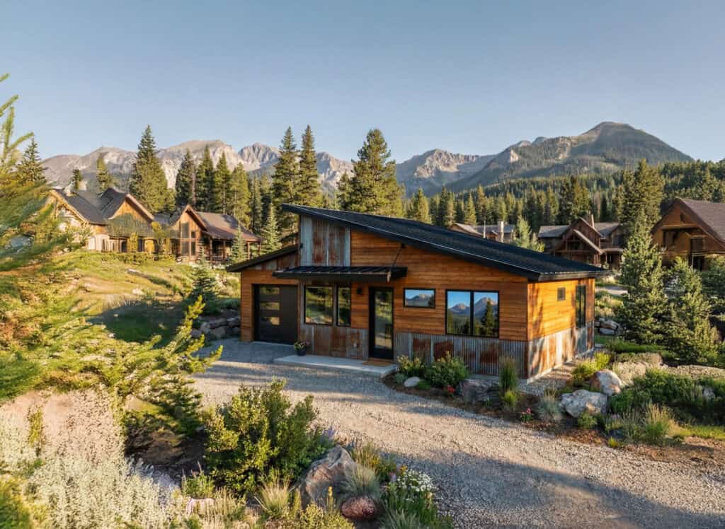 Bridger tiny home with mountain backdrop, wooden exterior, and scenic landscape.