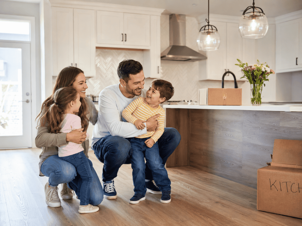 Happy family in a modern kitchen with white cabinets and island.