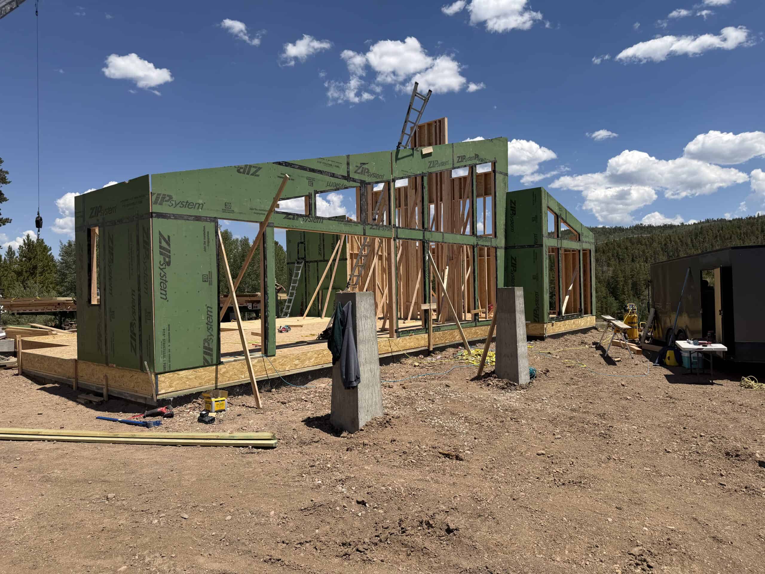 Construction of Zip Kit Homes frame on a clear day with blue sky.