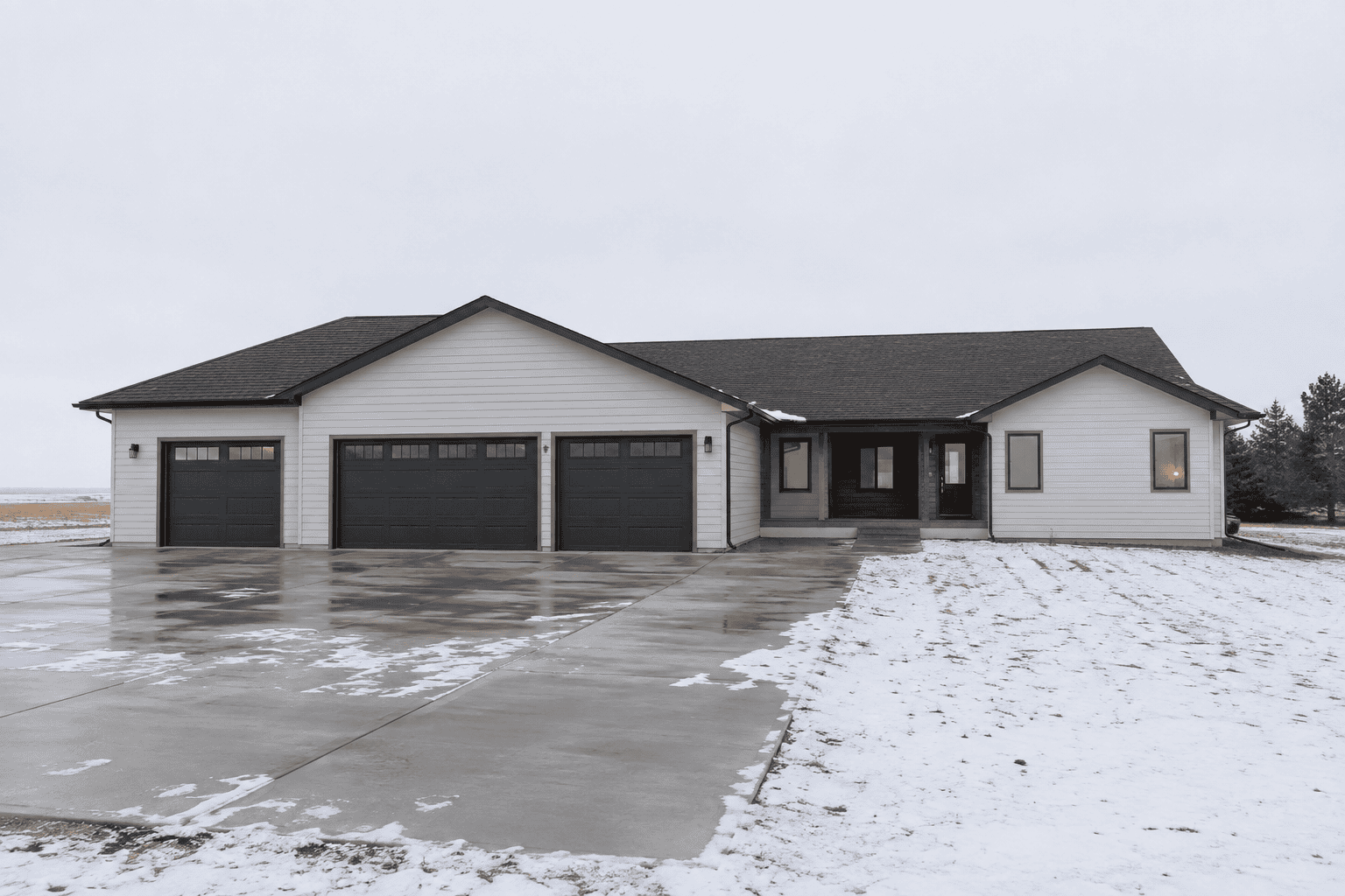 Contemporary Zip Kit home with attached garage in North Dakota winter.