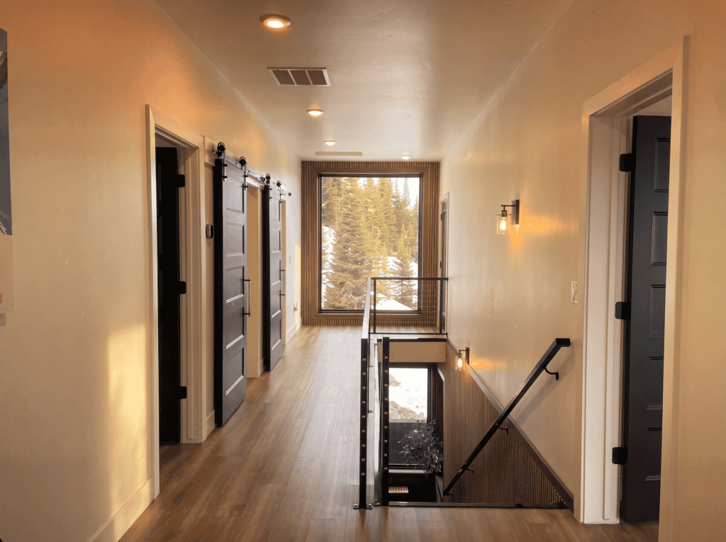 Bright hallway with large window and staircase in Zip Kit Home.
