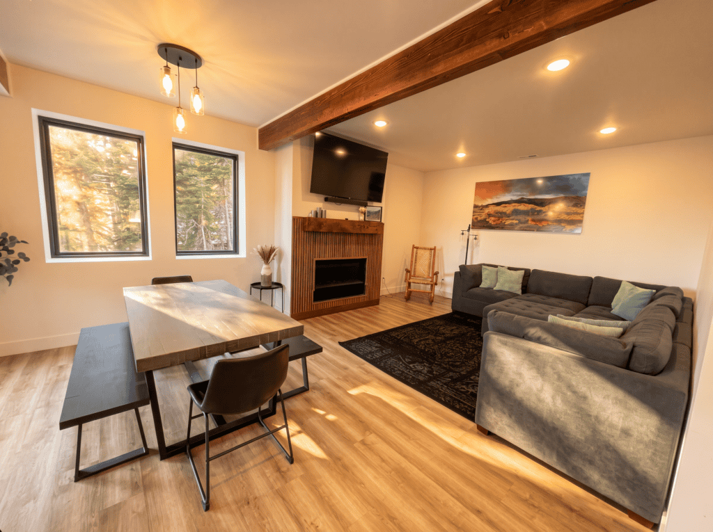 Spacious living room with large windows, fireplace, and modern furniture in a Zip Kit Home.